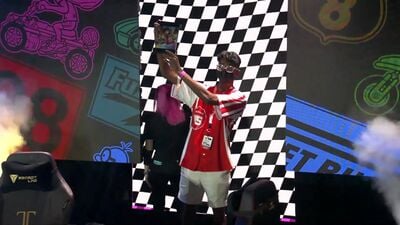 Player "Strike" holding his trophy after winning the Mario Kart 8 Deluxe Championship Cup 2022 invitational