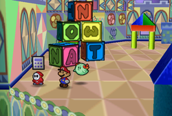 Mario finding Calculator held by a red Shy Guy in Shy Guy's Toy Box of Paper Mario.