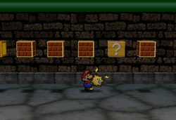 Image of Mario revealing a hidden ? Block in Toad Town Tunnels, in Paper Mario.